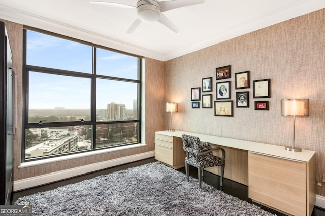 office space featuring wood finished floors, baseboards, ornamental molding, and wallpapered walls