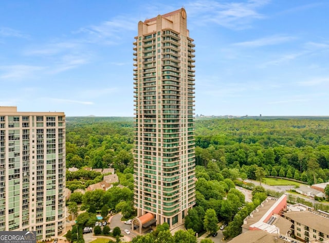 view of property featuring a wooded view