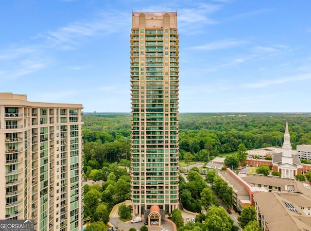 view of property featuring a wooded view