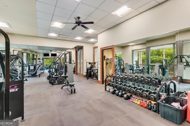 gym featuring a paneled ceiling and ceiling fan