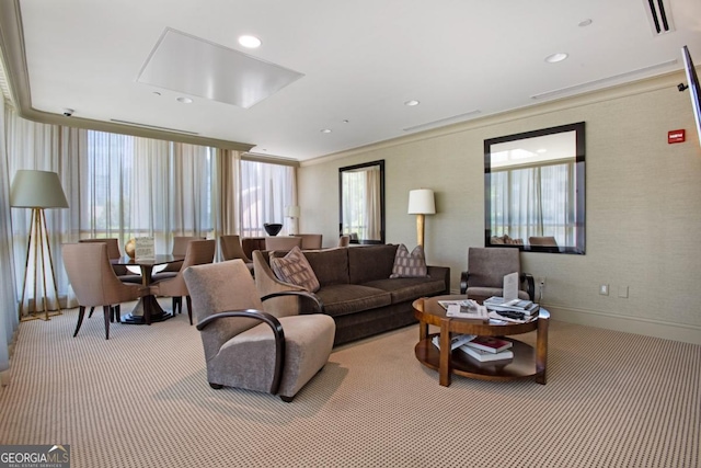 living room with carpet, visible vents, baseboards, recessed lighting, and crown molding