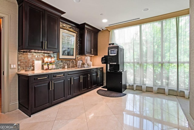 kitchen featuring decorative backsplash, light countertops, light tile patterned flooring, and recessed lighting