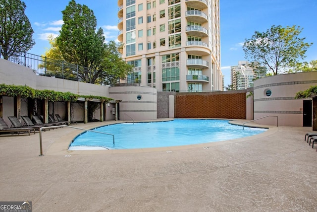 pool featuring a patio and fence