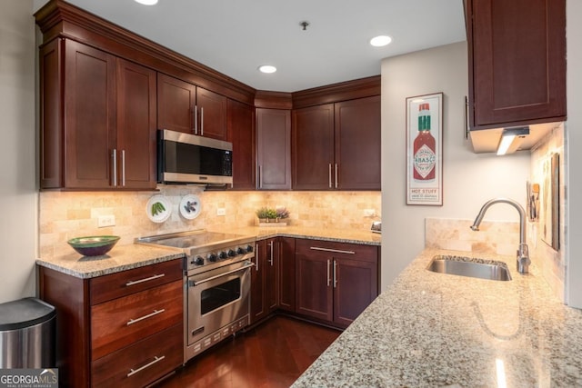 2660 Peachtree Rd NW Unit 14D, Atlanta, GA 30305 - kitchen with stainless steel appliances, a sink, light stone counters, tasteful backsplash, and dark wood-style floors