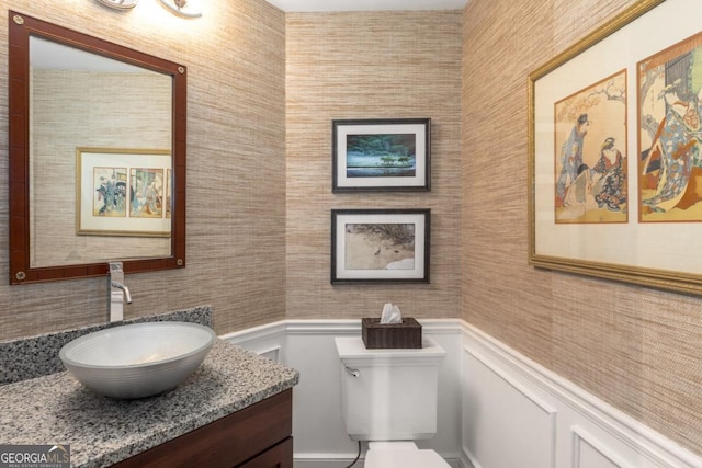 2660 Peachtree Rd NW Unit 14D, Atlanta, GA 30305 - bathroom featuring vanity, toilet, tile walls, and wainscoting