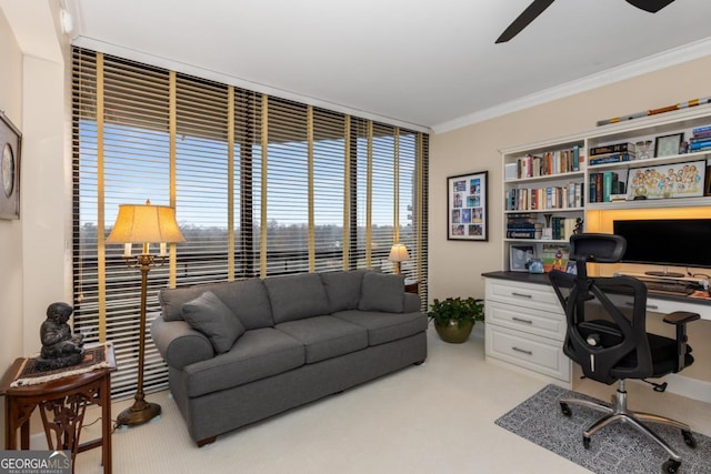 office with ceiling fan, light carpet, and ornamental molding