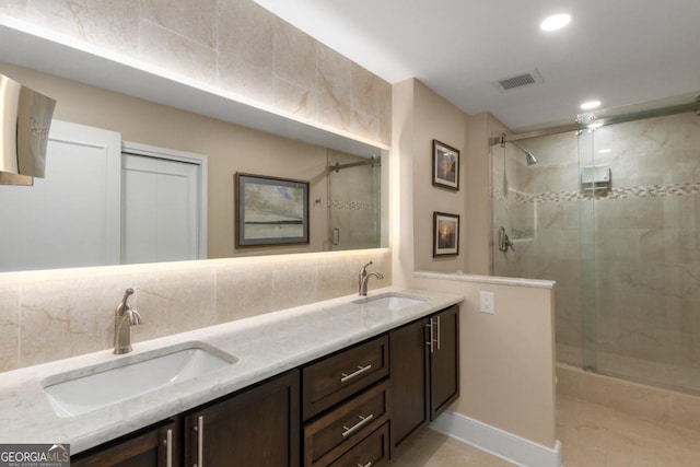 2660 Peachtree Rd NW Unit 14D, Atlanta, GA 30305 - bathroom with a stall shower, double vanity, backsplash, recessed lighting, and tile patterned floors