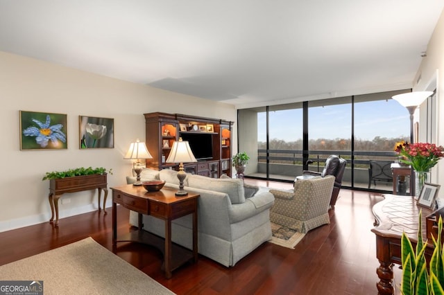 living area featuring a wall of windows, baseboards, and wood finished floors