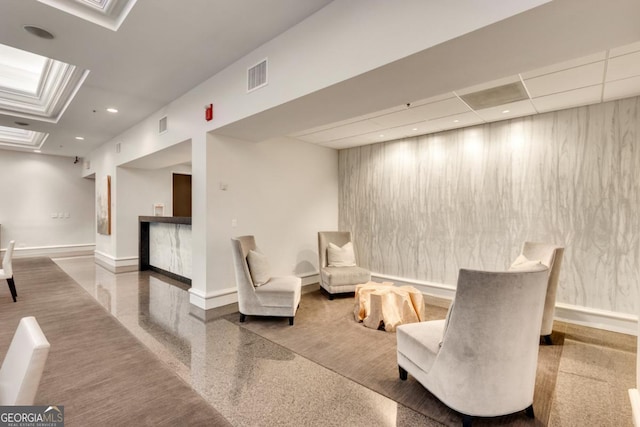 living area featuring speckled floor, recessed lighting, baseboards, and visible vents