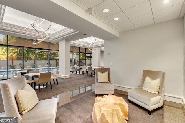 interior space with plenty of natural light, baseboards, and ornamental molding