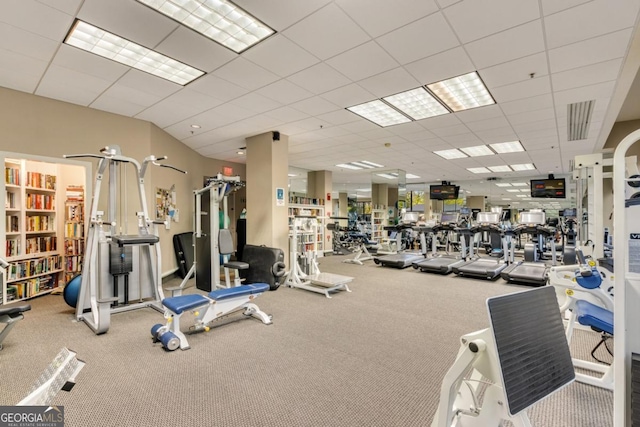 workout area featuring visible vents and a paneled ceiling