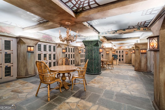 2660 Peachtree Rd NW Unit 14D, Atlanta, GA 30305 - dining area with stone tile flooring and a chandelier