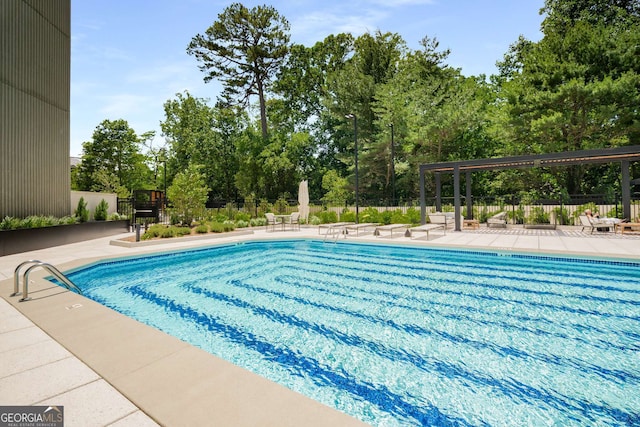 2660 Peachtree Rd NW Unit 14D, Atlanta, GA 30305 - community pool featuring a patio and view of wooded area
