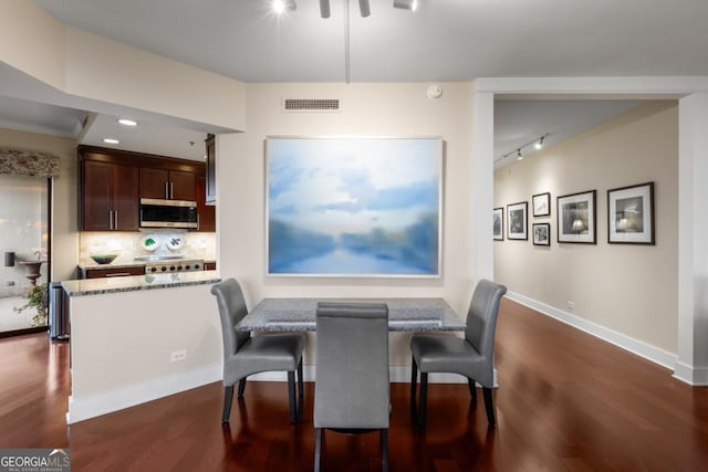 dining area featuring dark wood finished floors, recessed lighting, baseboards, and visible vents