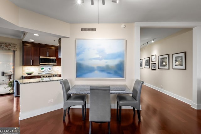 2660 Peachtree Rd NW Unit 14D, Atlanta, GA 30305 - dining area featuring dark wood finished floors, rail lighting, baseboards, and recessed lighting