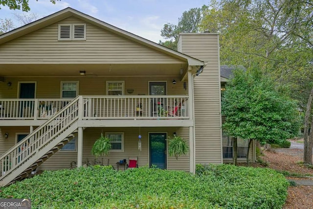 view of front of house with stairway and a chimney