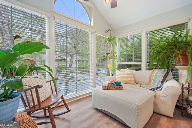 sunroom featuring lofted ceiling and a ceiling fan