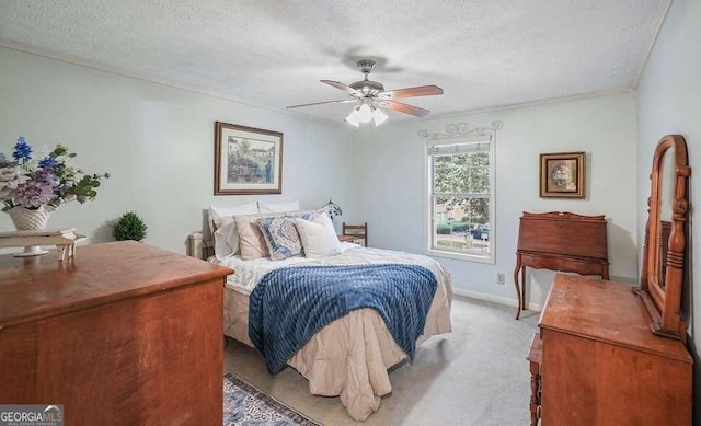 bedroom with light carpet, a ceiling fan, a textured ceiling, crown molding, and baseboards