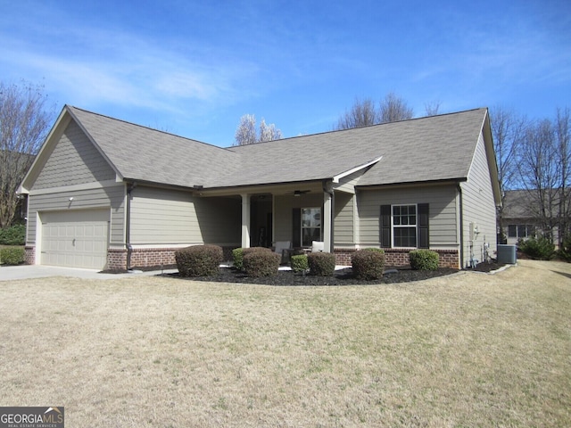 view of front of property with central air condition unit, a porch, an attached garage, a front yard, and brick siding