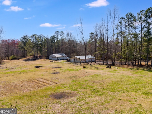 view of yard with a view of trees