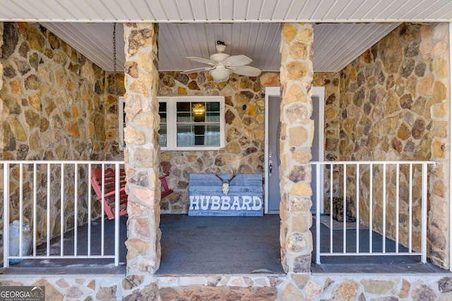 entrance to property with stone siding and ceiling fan