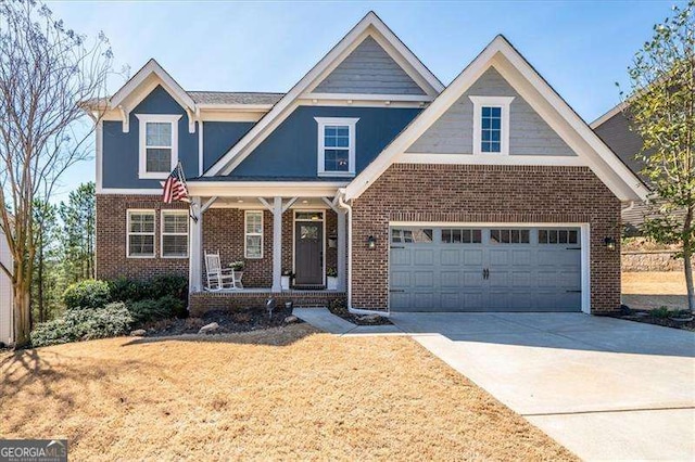 view of front facade featuring a porch, concrete driveway, brick siding, and a front lawn