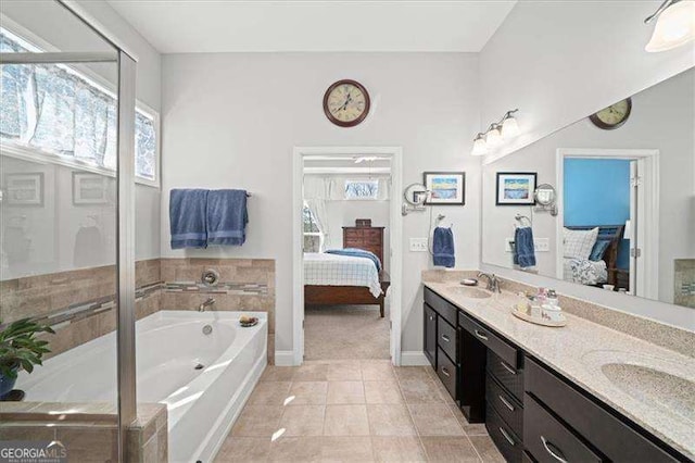 ensuite bathroom featuring ensuite bath, plenty of natural light, and a garden tub