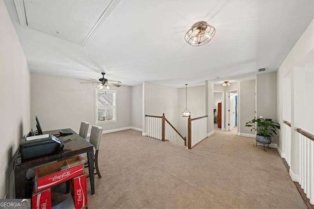 office space with baseboards, visible vents, light carpet, and attic access