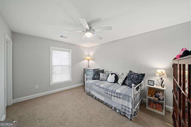 carpeted bedroom featuring visible vents, a ceiling fan, and baseboards