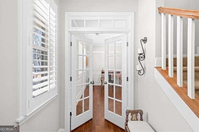 doorway featuring french doors and dark wood-style flooring