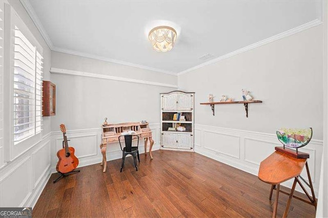 office area with wainscoting, ornamental molding, and dark wood-style flooring