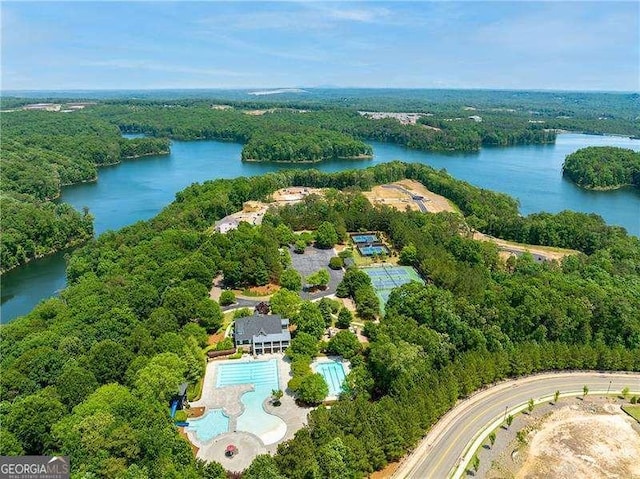 aerial view featuring a forest view and a water view