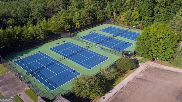 view of tennis court with fence