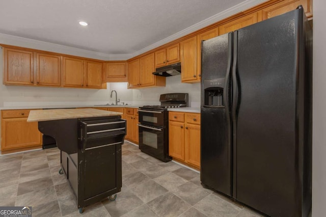 kitchen with black appliances, ornamental molding, under cabinet range hood, a sink, and a kitchen island