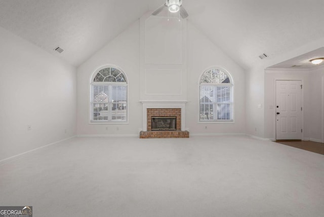 unfurnished living room featuring carpet, baseboards, visible vents, high vaulted ceiling, and a brick fireplace