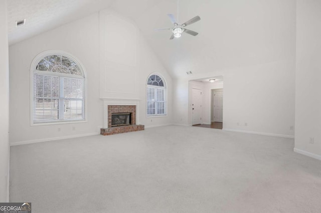 unfurnished living room featuring a fireplace, high vaulted ceiling, ceiling fan, and carpet floors