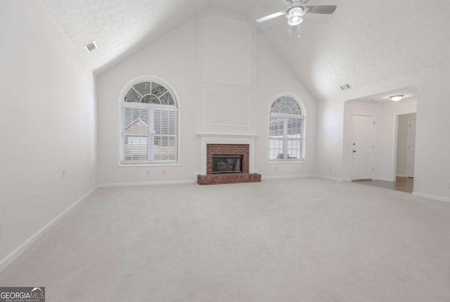 unfurnished living room featuring visible vents, a brick fireplace, baseboards, carpet, and high vaulted ceiling