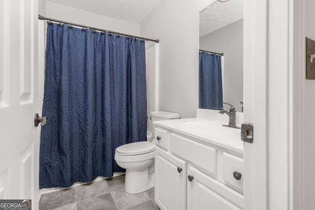 full bathroom featuring vanity, toilet, and a textured ceiling