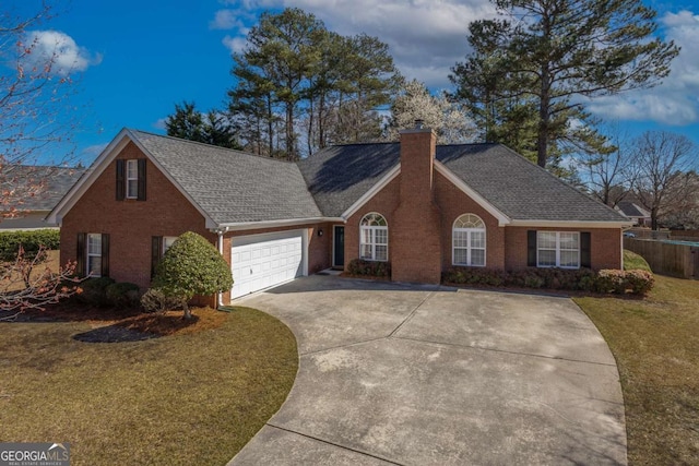 view of front of house with a front lawn, an attached garage, a shingled roof, brick siding, and a chimney