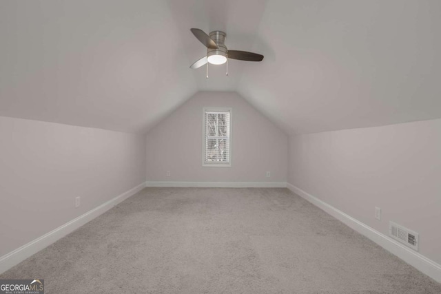 bonus room featuring visible vents, baseboards, carpet, and vaulted ceiling