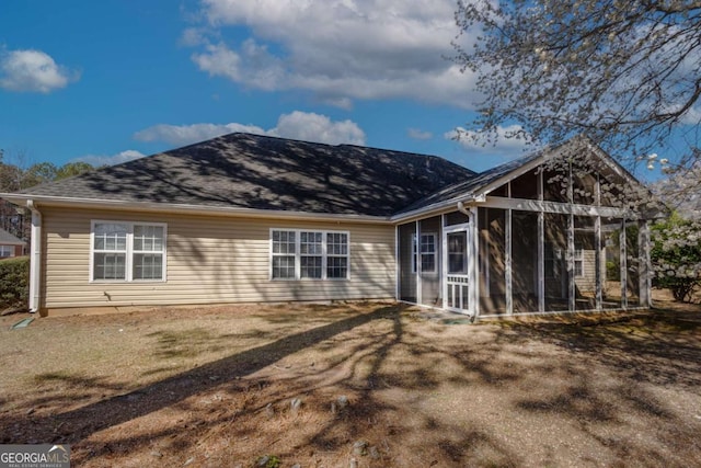 rear view of property featuring a sunroom