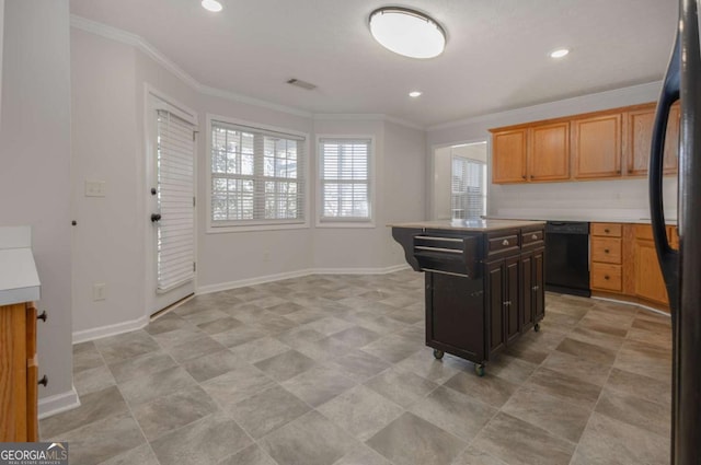 kitchen with visible vents, black appliances, light countertops, and ornamental molding