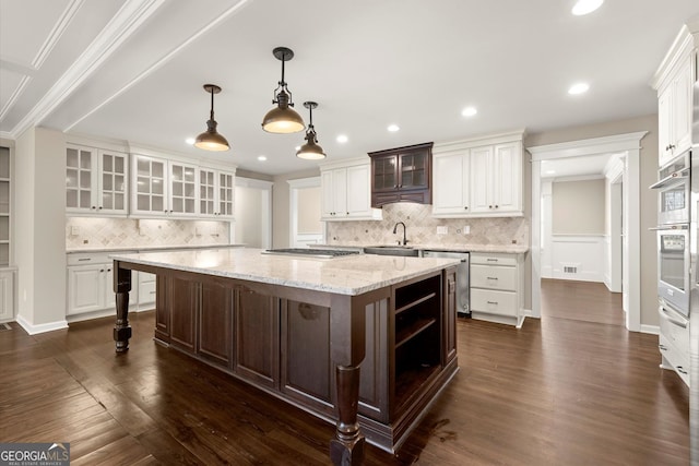 kitchen featuring a large island, dark wood-style floors, white cabinetry, and a sink