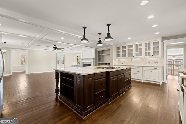 kitchen with dark brown cabinets, open floor plan, stainless steel gas stovetop, white cabinetry, and dark wood-style flooring