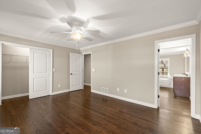 unfurnished bedroom with visible vents, baseboards, dark wood-style flooring, and crown molding