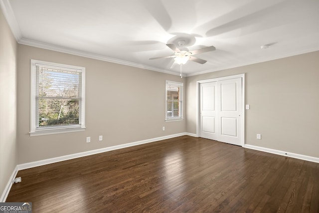 unfurnished bedroom featuring a closet, baseboards, dark wood-type flooring, and ornamental molding