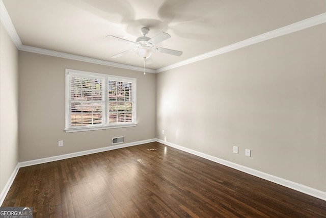 spare room with baseboards, visible vents, dark wood-style flooring, and ornamental molding