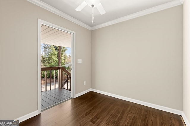 empty room featuring baseboards, dark wood-type flooring, and crown molding