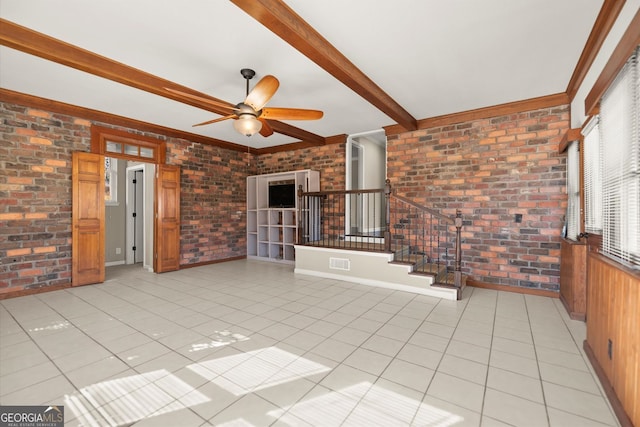 interior space with light tile patterned floors, beamed ceiling, and brick wall