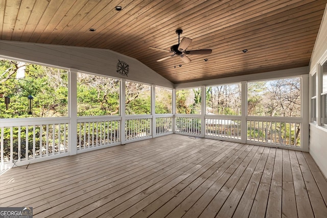 unfurnished sunroom featuring wood ceiling, lofted ceiling, and a ceiling fan